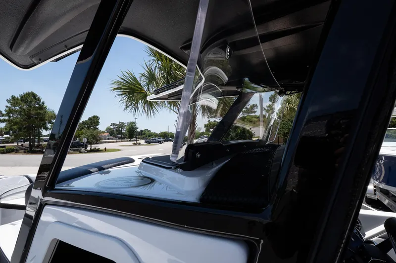  Yacht Photos Pics 2023 Sunsation 32 CCX boat windshield and console, with palm trees in the background.