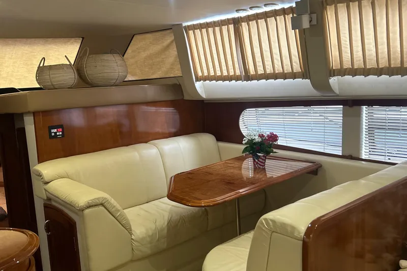  Yacht Photos Pics Luxurious interior of 2003 Carver 466 Motor Yacht with leather seating and wooden table.