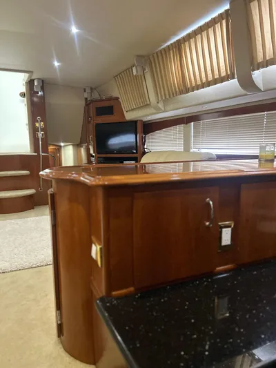  Yacht Photos Pics Interior of 2003 Carver 466 Motor Yacht with wood finishes and cozy seating area.