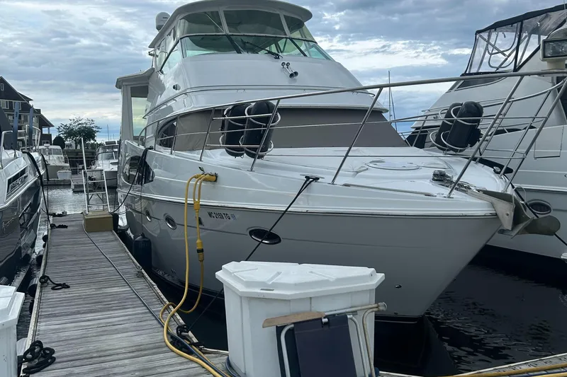  Yacht Photos Pics 2003 Carver 466 Motor Yacht docked at marina under cloudy sky.