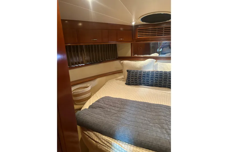  Yacht Photos Pics Luxurious bedroom interior of 2003 Carver 466 Motor Yacht with elegant bedding and wood finishes.