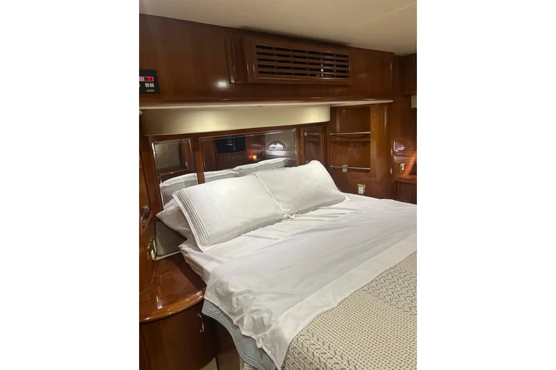  Yacht Photos Pics Luxurious bedroom interior of 2003 Carver 466 Motor Yacht with elegant wood finish.
