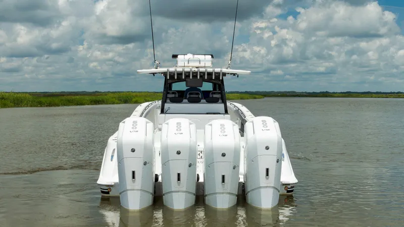 Traveller Yacht Photos Pics 2021 HCB Suenos boat with multiple outboard engines on a calm waterway.