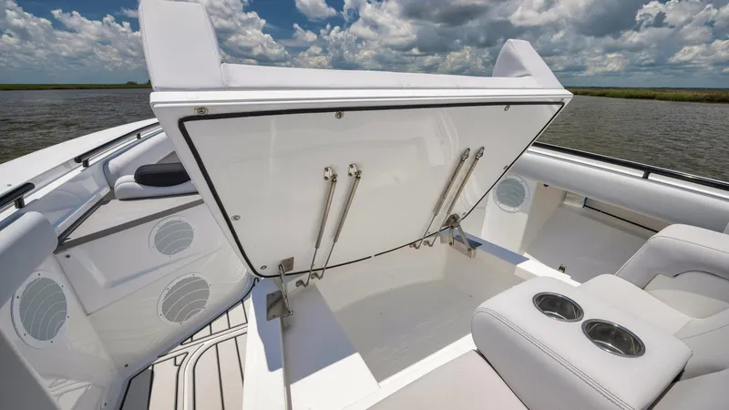 Traveller Yacht Photos Pics 2021 HCB Suenos boat interior with open storage compartment and cup holders.