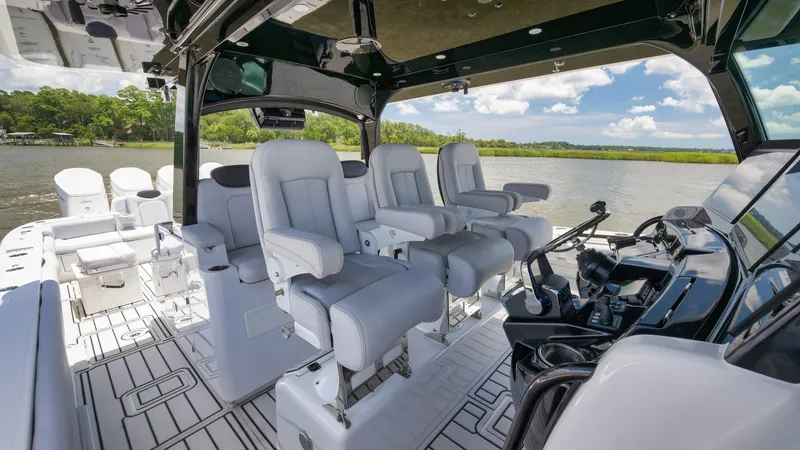 Traveller Yacht Photos Pics 2021 HCB Suenos boat interior with luxurious seating and modern controls on a sunny day.