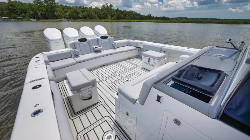 Traveller Yacht Photos Pics 2021 HCB Suenos boat with spacious deck and seating on a calm lake.