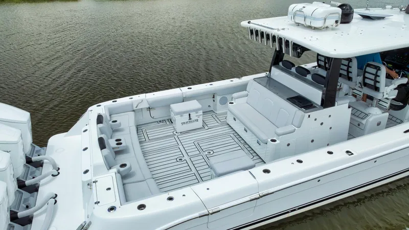 Traveller Yacht Photos Pics 2021 HCB Suenos boat with spacious deck and seating, docked on calm water.