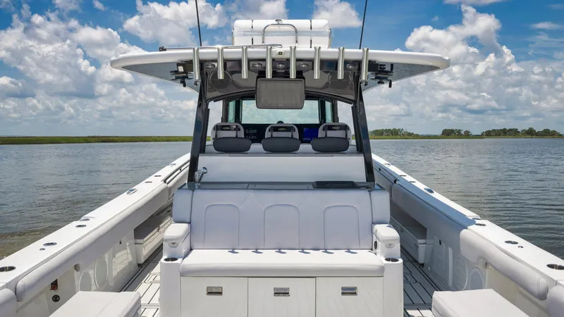 Traveller Yacht Photos Pics 2021 HCB Suenos boat interior with seating, rod holders, and open water view.