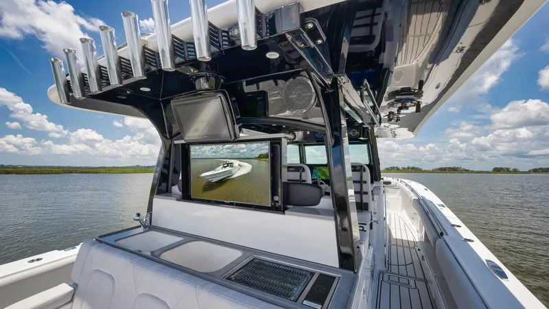 Traveller Yacht Photos Pics 2021 HCB Suenos boat interior with advanced navigation screens and fishing rod holders on a sunny day.