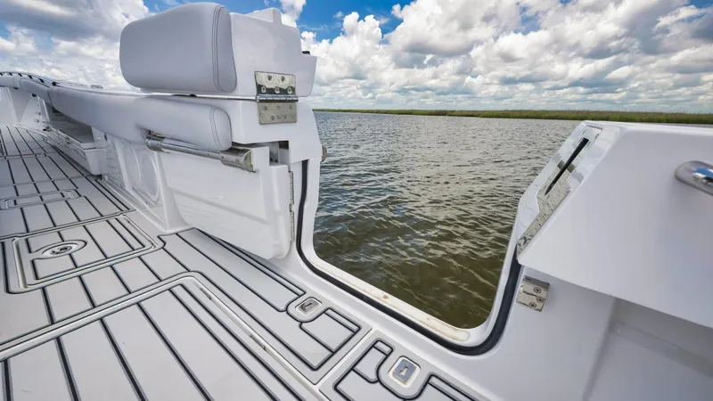 Traveller Yacht Photos Pics 2021 HCB Suenos boat interior with open side door, overlooking water and sky.