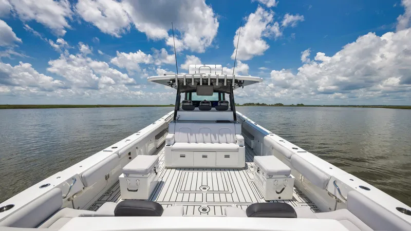 Traveller Yacht Photos Pics 2021 HCB Suenos boat on water under blue sky with clouds.