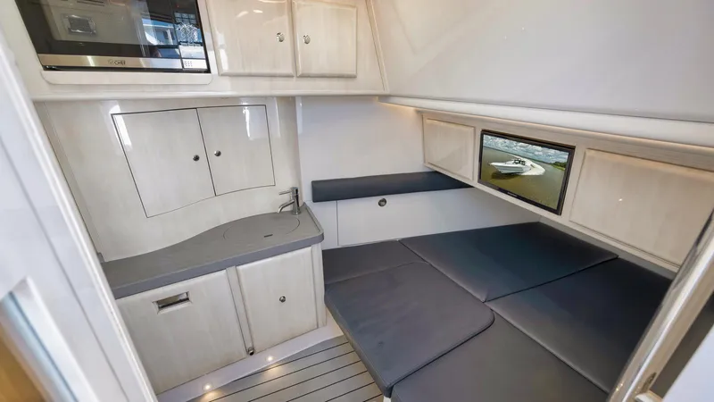 Traveller Yacht Photos Pics 2021 HCB Suenos cabin interior with kitchenette and seating area.