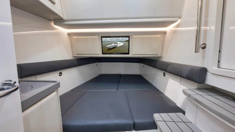 Traveller Yacht Photos Pics 2021 HCB Suenos cabin interior with seating and TV, featuring modern design and lighting.