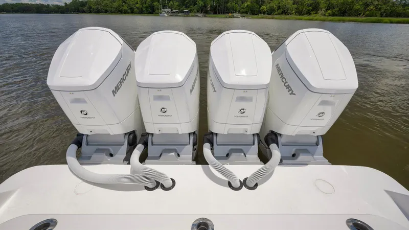 Traveller Yacht Photos Pics Four Mercury outboard engines on a 2021 HCB Suenos boat, docked on a calm river.