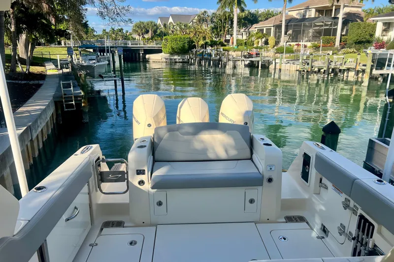  Yacht Photos Pics 2023 Scout 350 LXZ boat docked in a scenic waterfront setting.