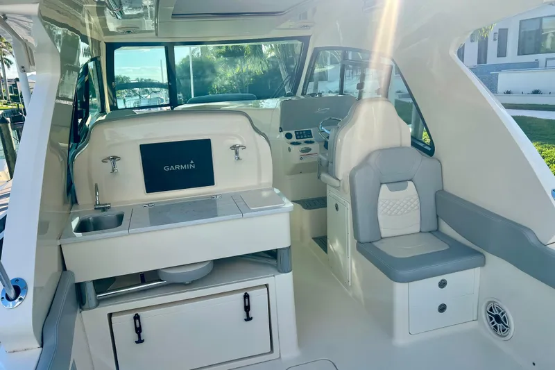  Yacht Photos Pics 2023 Scout 350 LXZ boat interior with Garmin system and seating area.