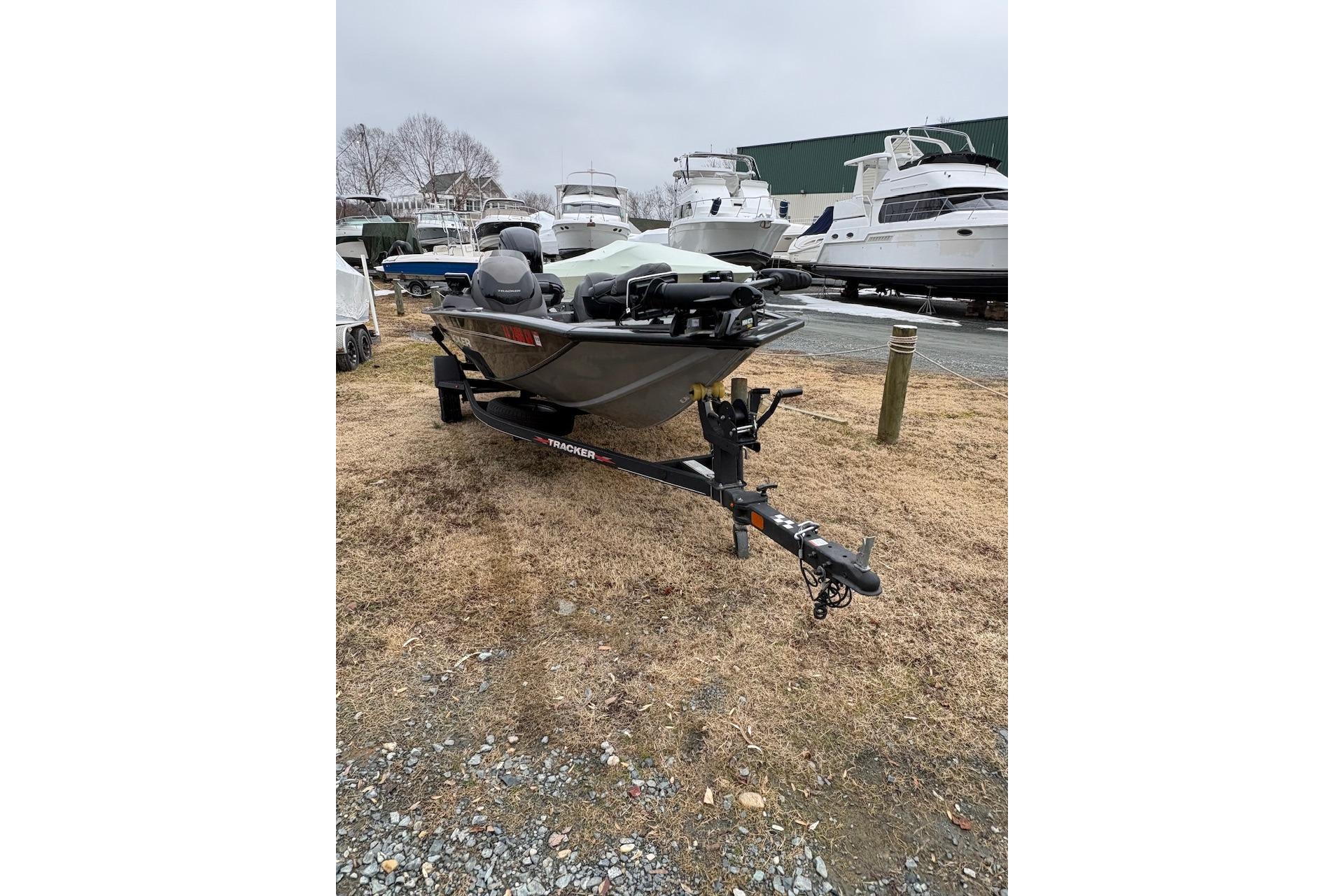 2023 Tracker Pro Team 175 TXW boat on trailer, parked outdoors near other boats.