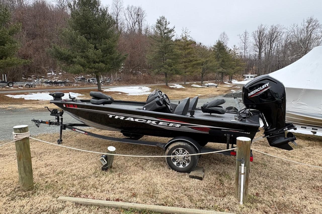 2023 Tracker Pro Team 175 TXW boat on trailer, parked outdoors in winter setting.