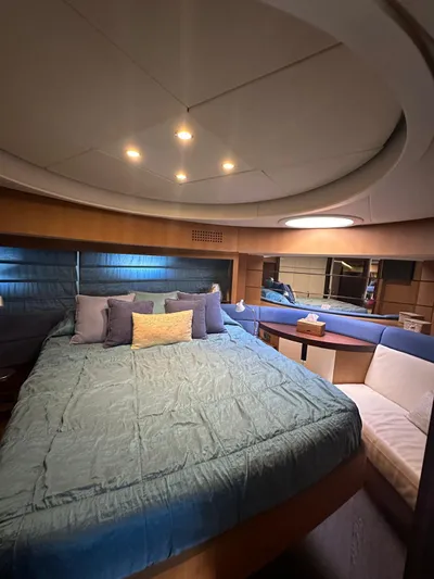  Yacht Photos Pics Luxurious bedroom interior of a 2006 Pershing 90 yacht with modern lighting and cozy seating.