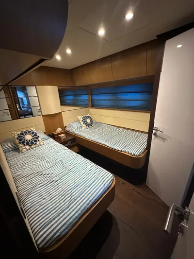  Yacht Photos Pics Twin cabin with striped bedding in 2006 Pershing 90 yacht.