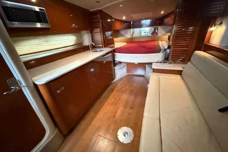  Yacht Photos Pics Interior of 2011 Sea Ray Sundancer 370 yacht with kitchen, seating, and bed.