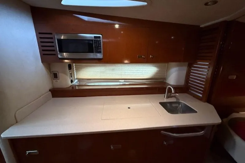  Yacht Photos Pics Interior of 2011 Sea Ray Sundancer 370 yacht kitchen with sink and microwave.