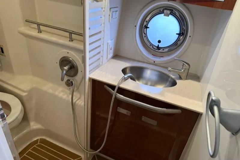  Yacht Photos Pics 2011 Sea Ray Sundancer 370 bathroom with sink, shower, and porthole window.