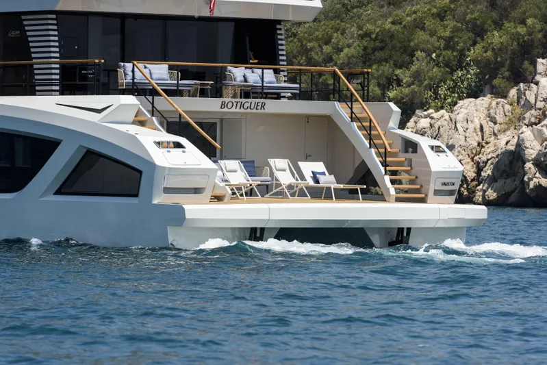 Lazzara Lpc 300 Yacht Photos Pics Luxury Lazzara LPC 300 yacht, 2027 model, cruising near rocky coastline with sun loungers.