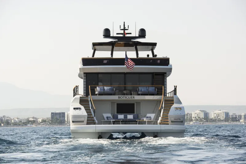 Lazzara Lpc 300 Yacht Photos Pics 2027 Lazzara LPC 300 yacht on water, rear view with cityscape background.