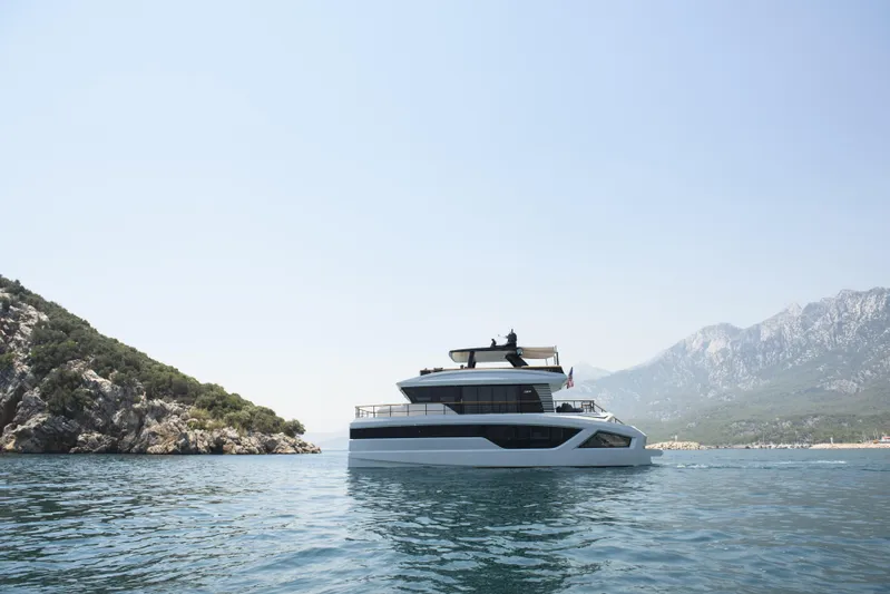 Lazzara Lpc 300 Yacht Photos Pics Luxurious 2027 Lazzara LPC 300 yacht cruising near scenic rocky coastline.