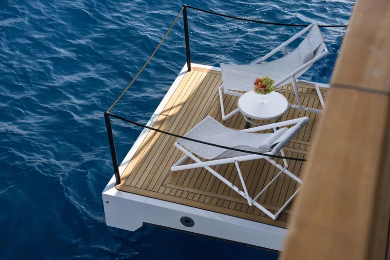 Lazzara Lpc 300 Yacht Photos Pics Luxury deck of 2027 Lazzara LPC 300 yacht with chairs and table by the sea.