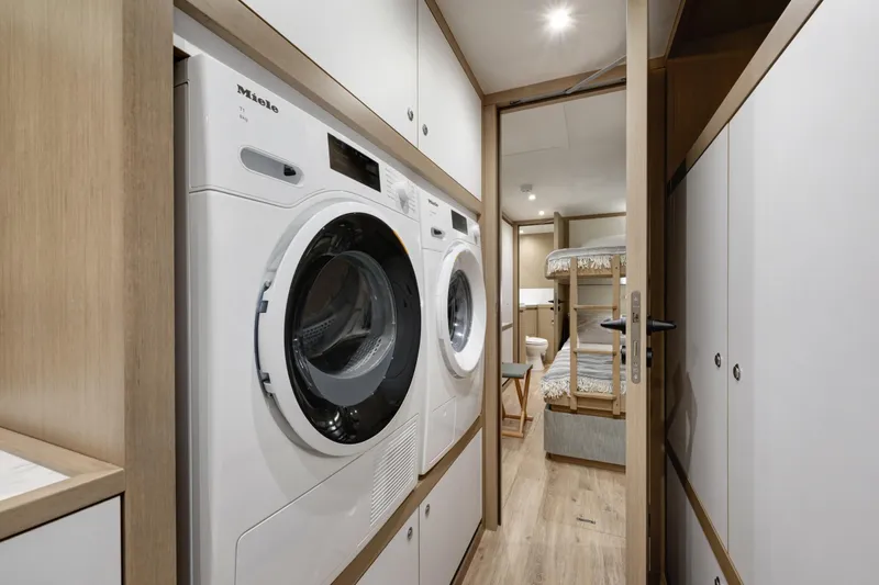 Lazzara Lpc 300 Yacht Photos Pics Laundry area with washer and dryer in 2027 Lazzara LPC 300 yacht interior.