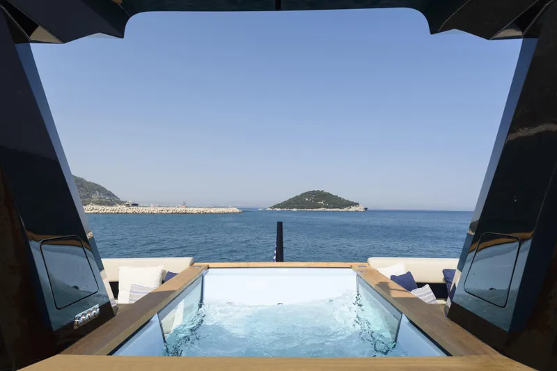 Lazzara Lpc 300 Yacht Photos Pics Luxurious Lazzara LPC 300 yacht with pool, ocean view, and island backdrop, 2027 model.