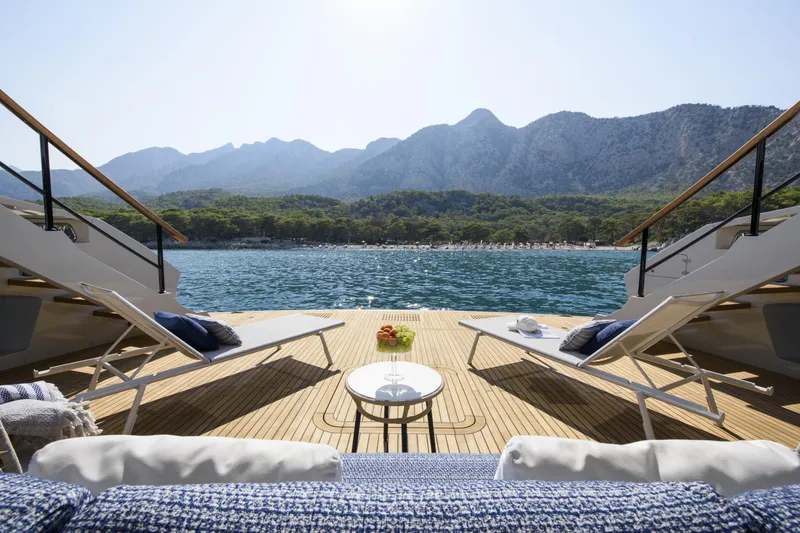 Lazzara Lpc 300 Yacht Photos Pics Luxurious Lazzara LPC 300 yacht deck with lounge chairs, overlooking serene waters and mountains, 2027 model.