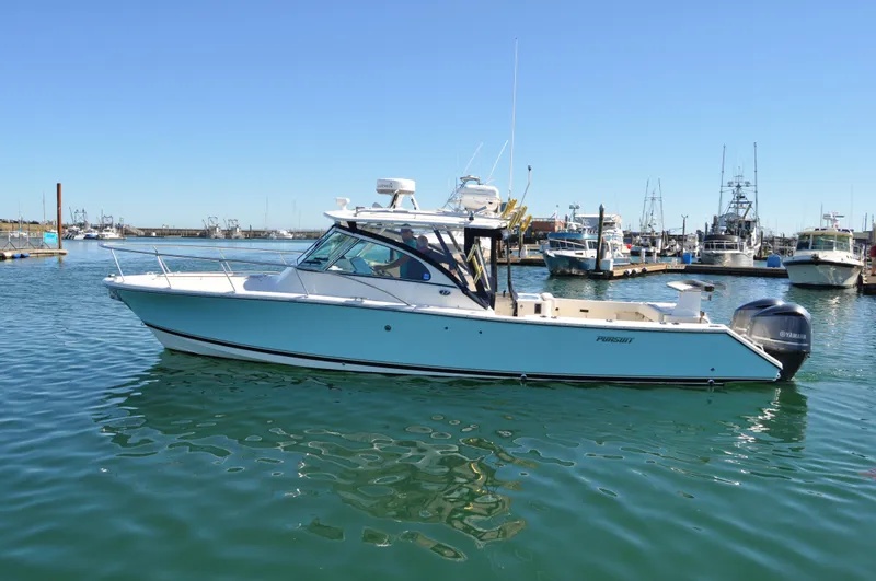  Yacht Photos Pics 2006 Pursuit 345 Drummond Island Sportfish boat on calm water, docked in a marina.