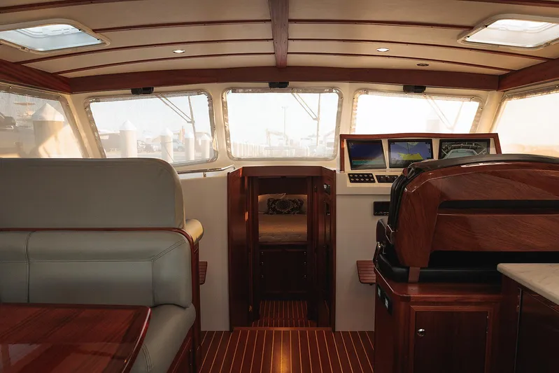  Yacht Photos Pics Luxurious interior of 2022 Composite Yacht CY46 with wood finishes and navigation screens.
