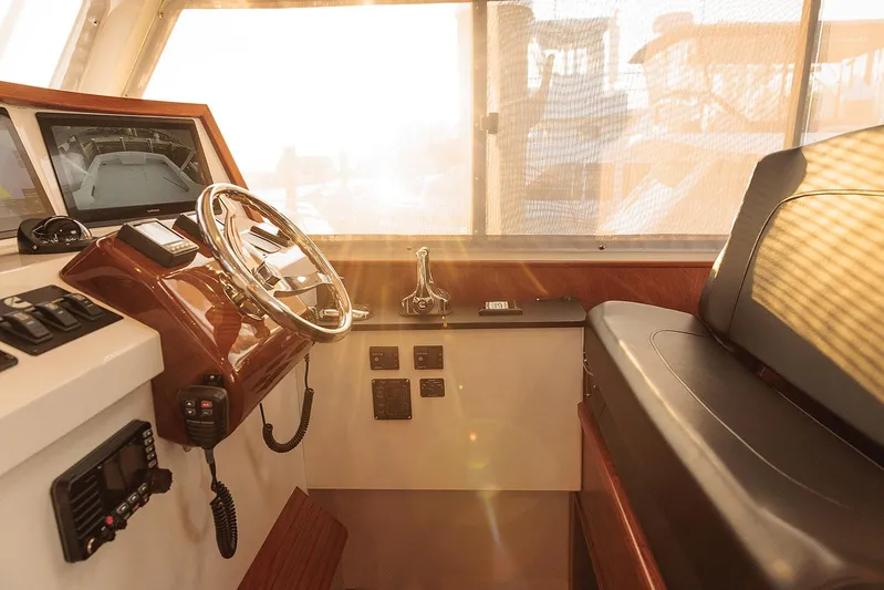  Yacht Photos Pics Helm of 2022 Composite Yacht CY46 with steering wheel and navigation controls in sunlight.
