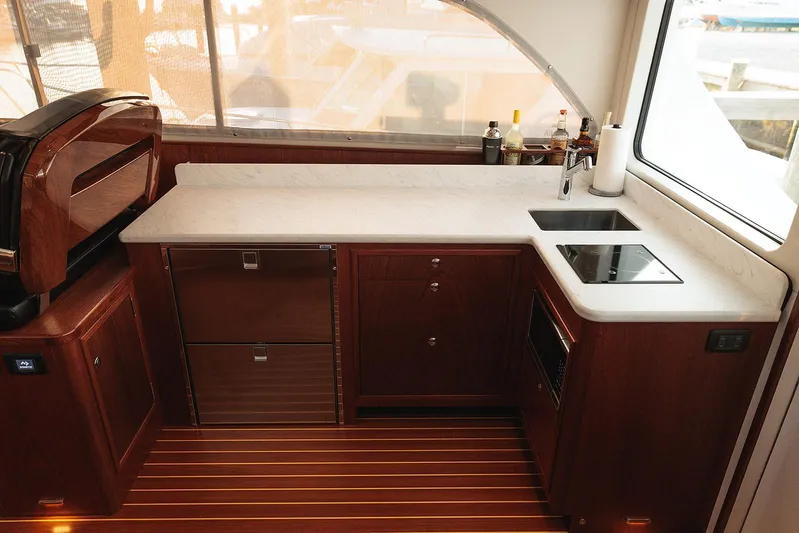  Yacht Photos Pics Luxurious kitchen in 2022 Composite Yacht CY46 with modern appliances and elegant wood finish.