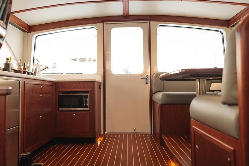 Yacht Photos Pics Interior of 2022 Composite Yacht CY46, featuring wood cabinetry and seating.
