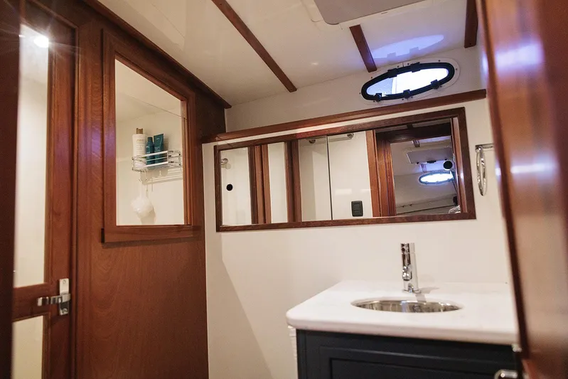  Yacht Photos Pics Luxurious bathroom interior of 2022 Composite Yacht CY46 with wooden accents and modern fixtures.