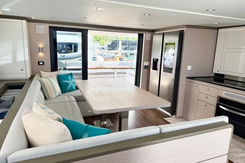  Yacht Photos Pics Modern interior of 2026 Aventura 56 Motor Yacht with elegant dining area and kitchen.