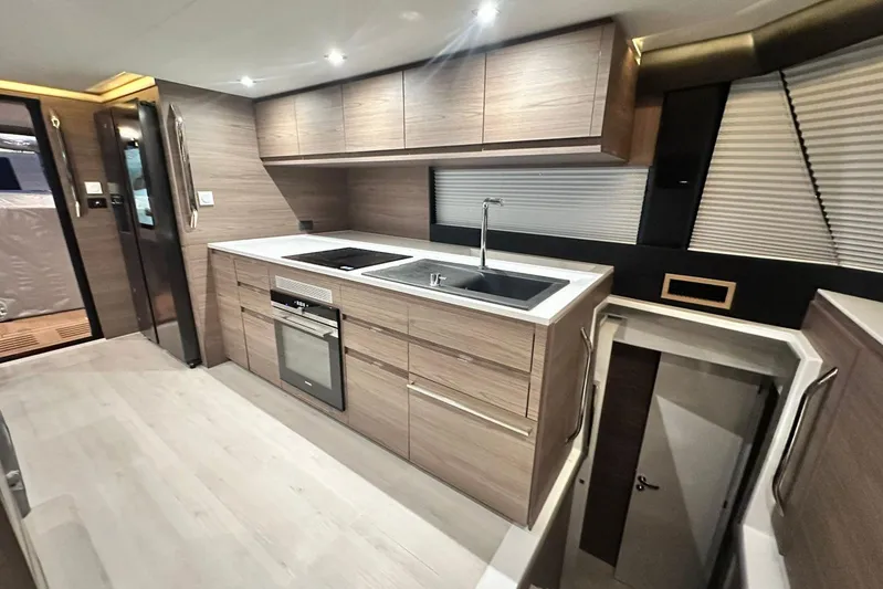  Yacht Photos Pics Modern kitchen interior of 2026 Aventura 56 Motor Yacht with sleek cabinetry and appliances.