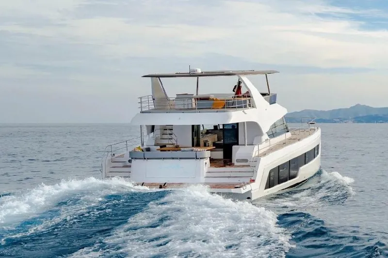  Yacht Photos Pics Aventura 56 Motor Yacht 2026 cruising on open sea, rear view.