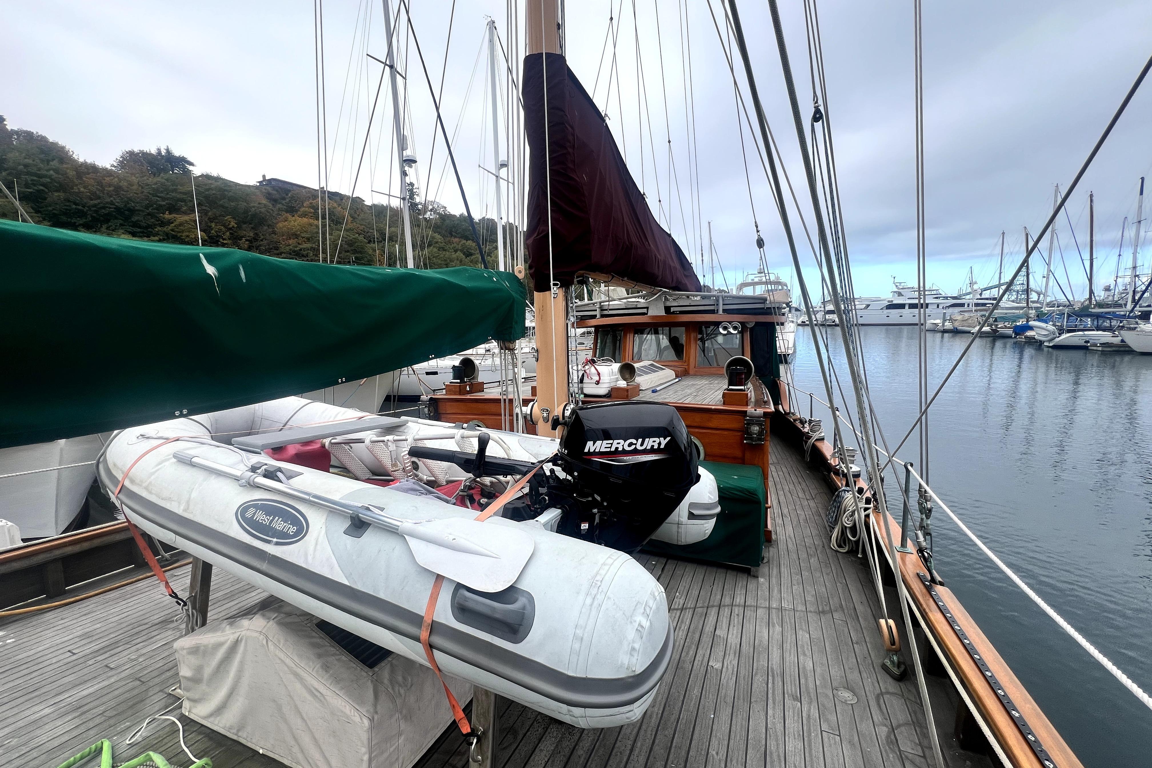 1934 Pankey Schooner docked with inflatable boat and Mercury motor.