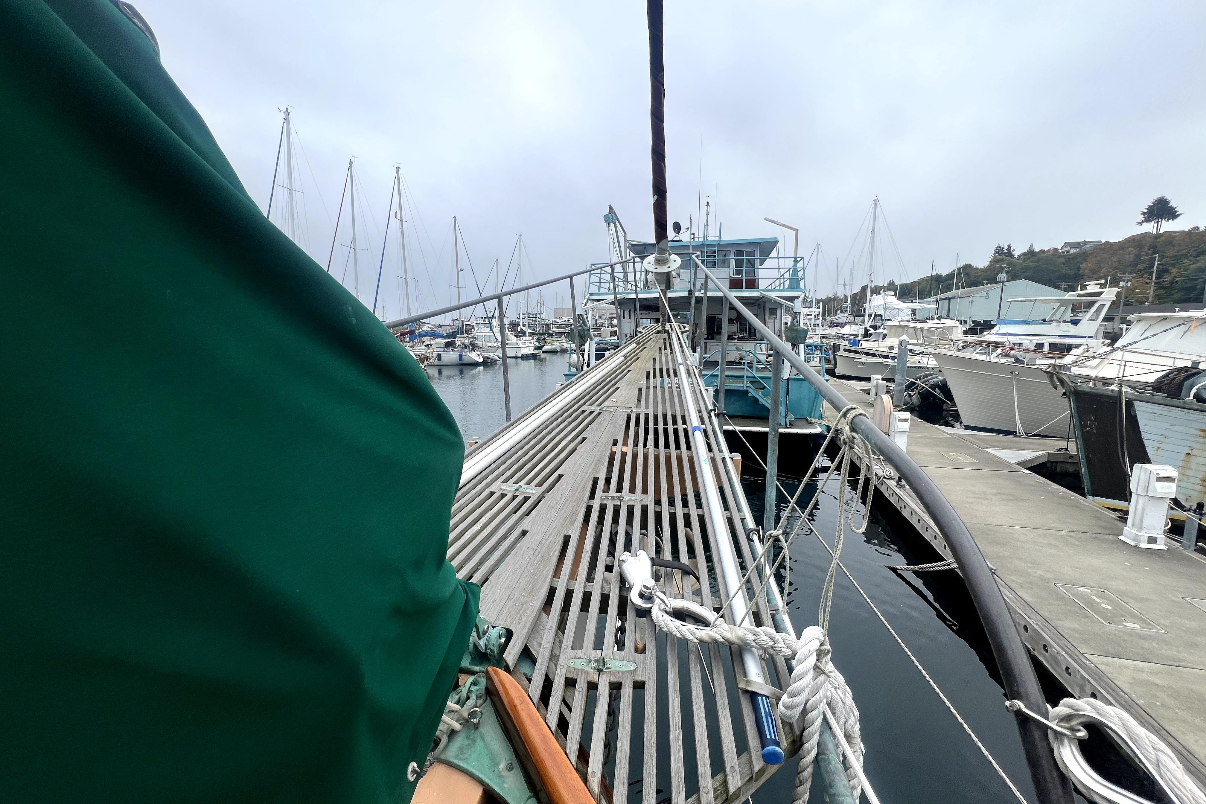 1934 Pankey Schooner docked at a marina, surrounded by other boats.