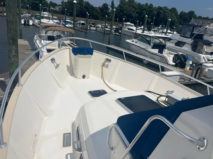  Yacht Photos Pics 1998 Cherubini Independence boat docked at marina, featuring spacious deck and railing.
