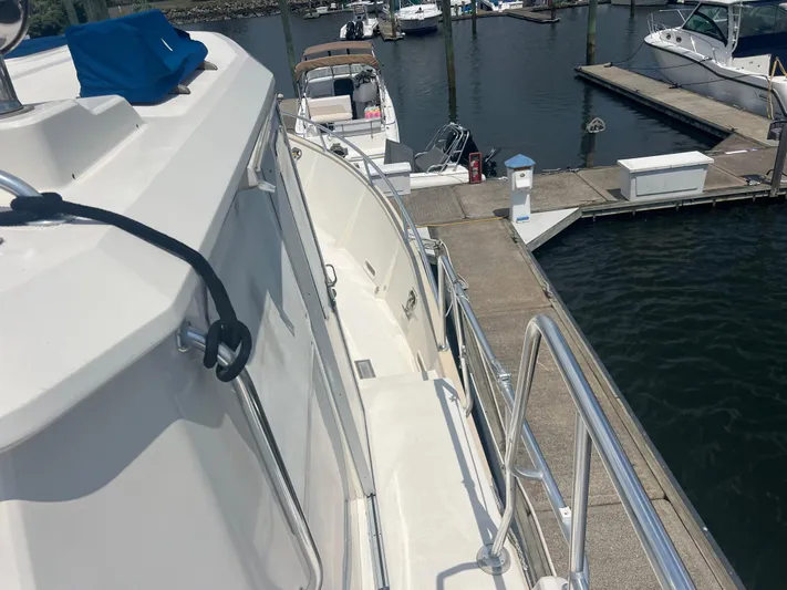  Yacht Photos Pics 1998 Cherubini Independence yacht docked at marina, featuring sleek design and polished railings.