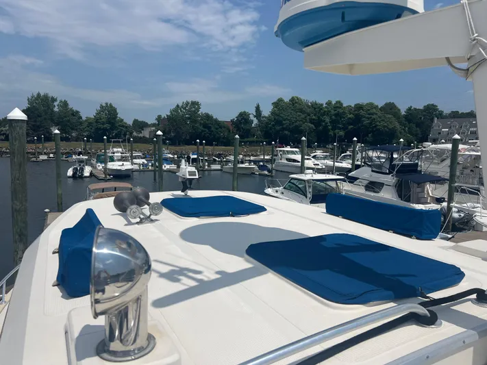  Yacht Photos Pics 1998 Cherubini Independence yacht docked at marina, featuring blue cushions and clear sky.
