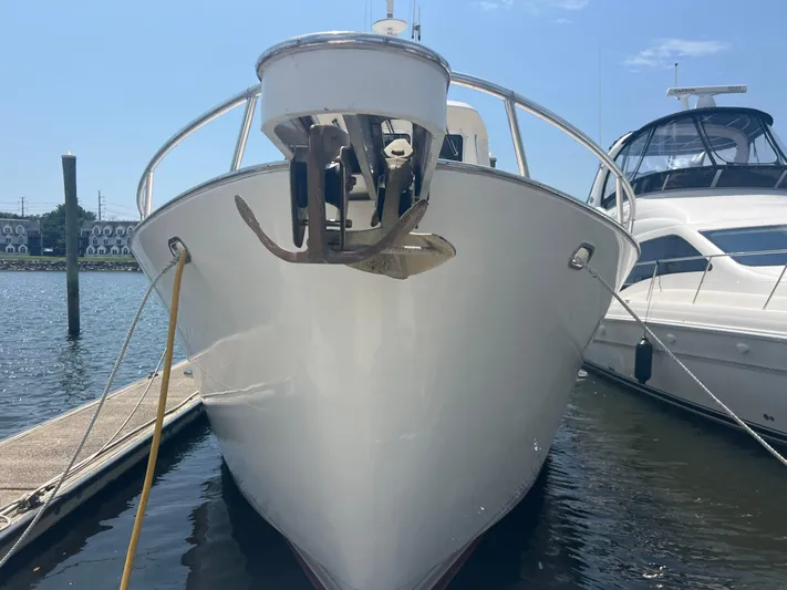  Yacht Photos Pics Cherubini Independence 1998 yacht docked at marina, front view with anchor visible.