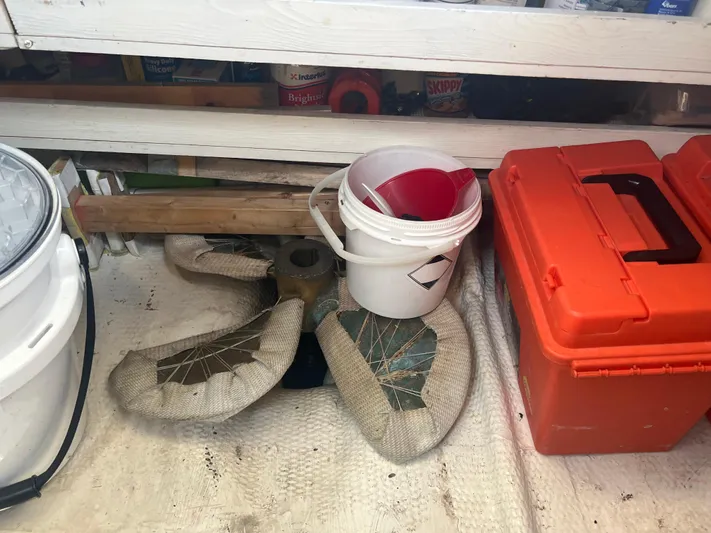  Yacht Photos Pics Storage area with tools, buckets, and a wrapped propeller from a 1998 Cherubini Independence.